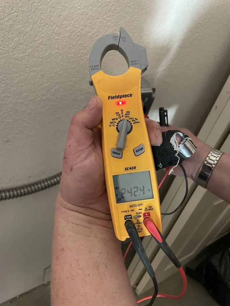 Voltage testing with clamp meter during Electrical Installation Services in Ravena